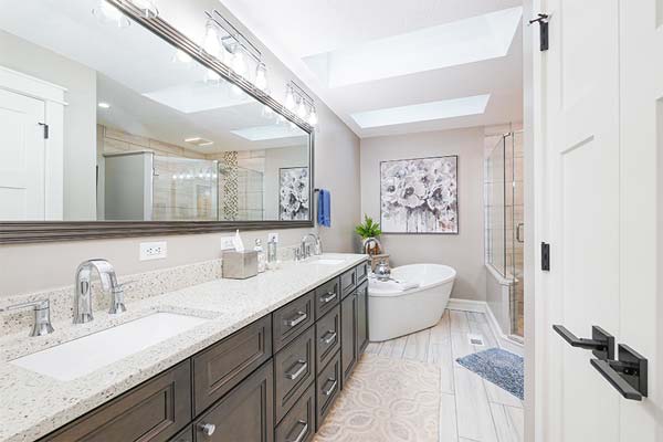 Beautiful bathroom with granite countertop and dark wood cabinets.