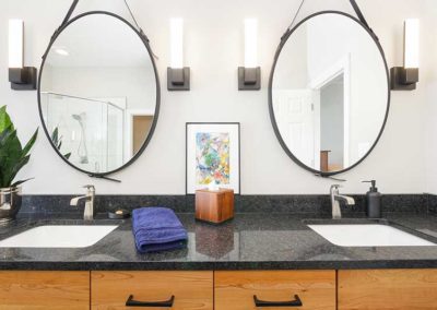 Master bathroom sink with separate oval mirrors.