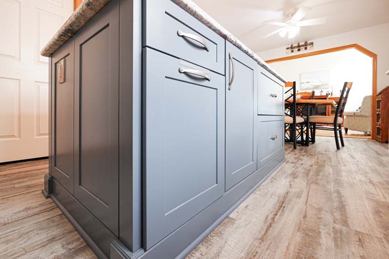 Grey cabinets island in the open space kitchen.