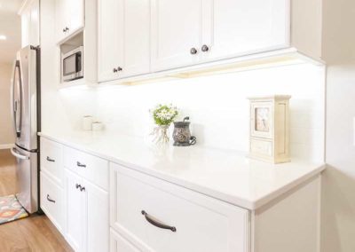 White kitchen cabinets with new appliances.