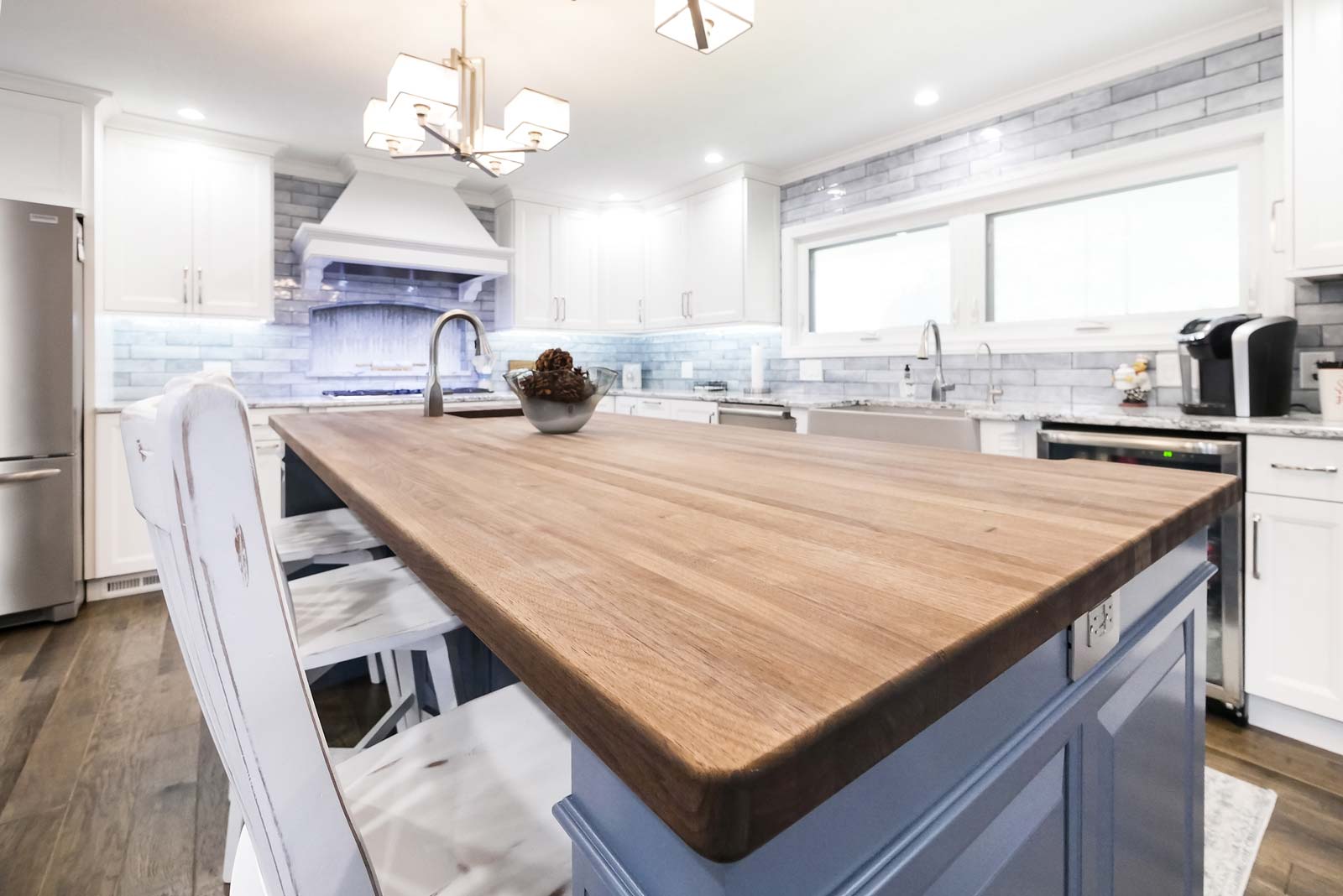Kitchen island with solid wooden countertop and a sink.