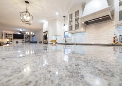 Granite countertop on an island in an open space kitchen.