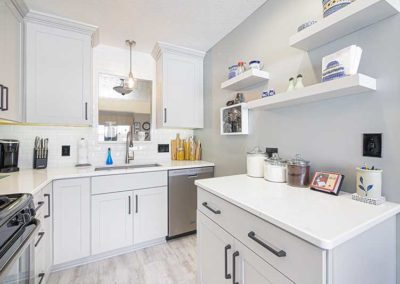 Kitchen with white cabinets and quartz countertops.