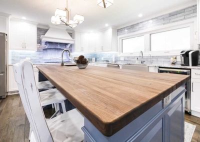 Wooden countertop on a grey-blue island.