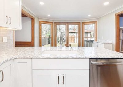 White granite countertops in an open space kitchen.