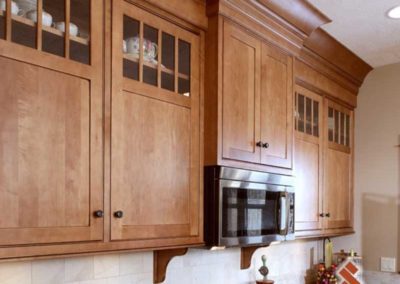 Extra storage space on top of wooden kitchen cabinets.